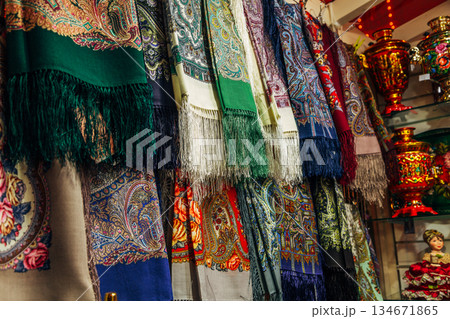 Russian colorful traditional scarfs for sale in a gift shop 134671865