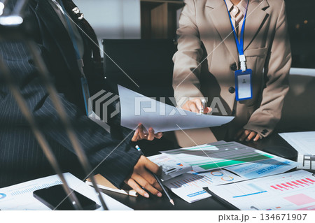 Close up high angle Asian businesswoman working with her coworker in meeting room Close up high angle Asian businesswoman working with her coworker in meeting room 134671907
