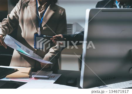 Close up high angle Asian businesswoman working with her coworker in meeting room Close up high angle Asian businesswoman working with her coworker in meeting room 134671917