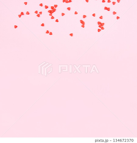 Tiny red hearts on pink background. Tiny red hearts on pink background. 134672370