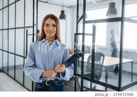 Against her colleagues. Professional workers are in the modern office together Against her colleagues. Professional workers are in the modern office together 134672480