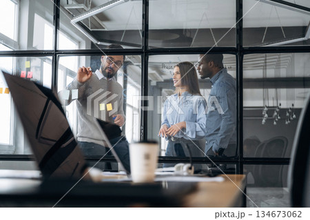 Tactics, planning the job. Professional workers are in the modern office together Tactics, planning the job. Professional workers are in the modern office together 134673062