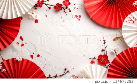 和紙に紅白の扇と梅の花の和風背景 134673282