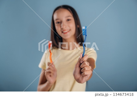 Conception of personal hygiene, with toothbrush. Young girl is against background 134673418