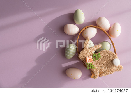 Pastel Easter Bunny Basket with Eggs and Flowers on Lavender Background Pastel Easter Bunny Basket with Eggs and Flowers on Lavender Background 134674087