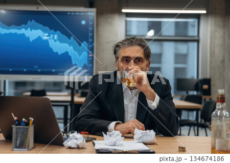 Alcohol on the work, drinking, depression. Senior man is in the modern office 134674186