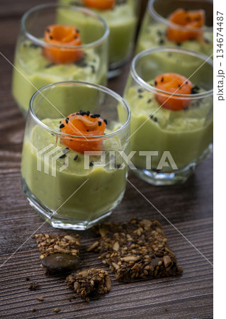 Smoked salmon shot glasses guacamole served with homemade crackers Smoked salmon shot glasses guacamole served with homemade crackers 134674487