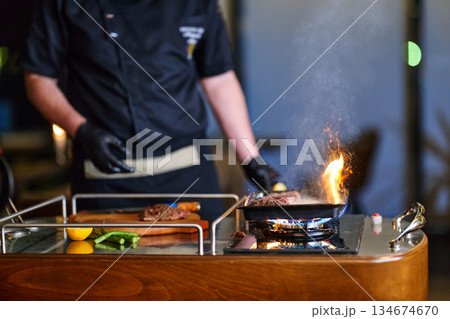 Grilling beef during iftar with family in a cozy setting at sunset in a city restaurant for Ramadan gathering Grilling beef during iftar with family in a cozy setting at sunset in a city restaurant for Ramadan gathering 134674670