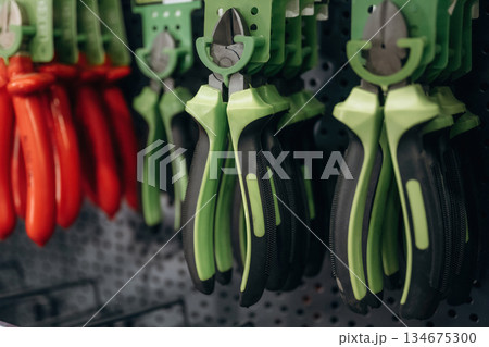 Many of pliers on the wall in the hardware store 134675300
