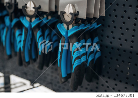 Many of pliers on the wall in the hardware store 134675301