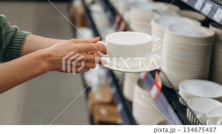 White new cup. Close up view of woman that is in the hardware store 134675487