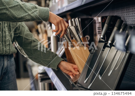 Sharp knives. Close up view of woman that is in the hardware store 134675494