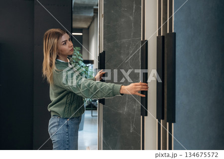 Woman is in the hardware store, shopping conception Woman is in the hardware store, shopping conception 134675572