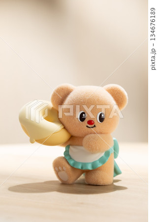 Backlit ButterBear Toy Holding a Large Donut on Fabric Surface Backlit ButterBear Toy Holding a Large Donut on Fabric Surface 134676189