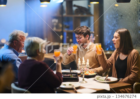 Family gathers for iftar celebration during Ramadan with traditional food and drinks at a cozy restaurant setting 134676274