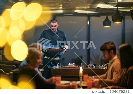 Family gathers at together for iftar meal during Ramadan in a cozy restaurant setting Family gathers at together for iftar meal during Ramadan in a cozy restaurant setting 134676281