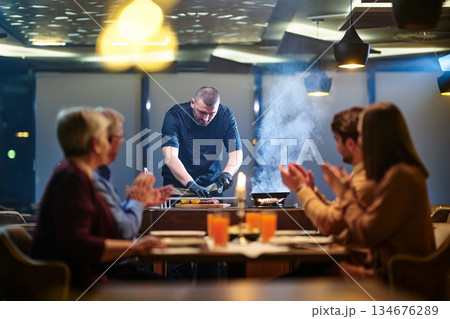 Gathering around the table for iftar meal during Ramadan with family and friends in a modern restaurant setting Gathering around the table for iftar meal during Ramadan with family and friends in a modern restaurant setting 134676289