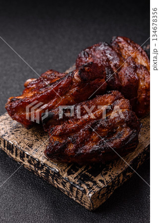 Grilled or barbecued pork ribs with sauce. Grilled ribs 134678356