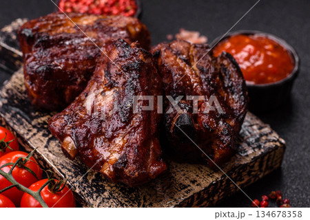 Grilled or barbecued pork ribs with sauce. Grilled ribs 134678358