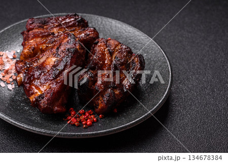 Grilled or barbecued pork ribs with sauce. Grilled ribs Grilled or barbecued pork ribs with sauce. Grilled ribs 134678384