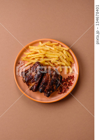 Grilled or barbecued pork ribs with sauce. Grilled ribs Grilled or barbecued pork ribs with sauce. Grilled ribs 134678401