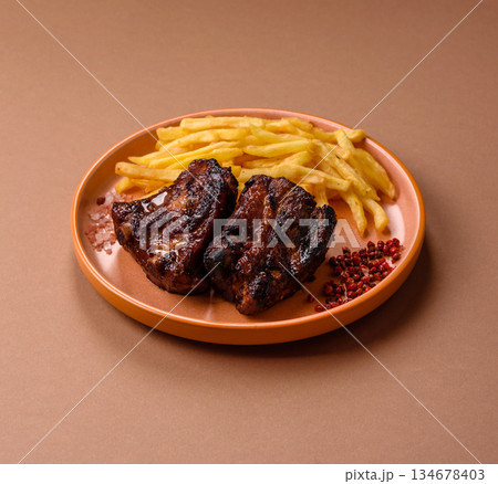 Grilled or barbecued pork ribs with sauce. Grilled ribs Grilled or barbecued pork ribs with sauce. Grilled ribs 134678403