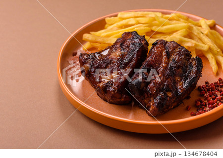Grilled or barbecued pork ribs with sauce. Grilled ribs Grilled or barbecued pork ribs with sauce. Grilled ribs 134678404