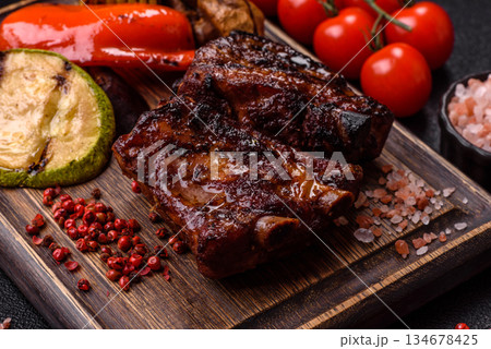Grilled or barbecued pork ribs with sauce. Grilled ribs Grilled or barbecued pork ribs with sauce. Grilled ribs 134678425