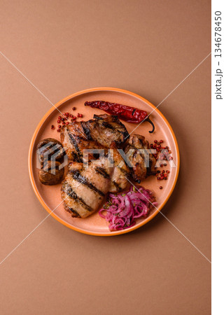 Chicken breast cooked on a grill or barbecue with sauce. Grilled chicken Chicken breast cooked on a grill or barbecue with sauce. Grilled chicken 134678450