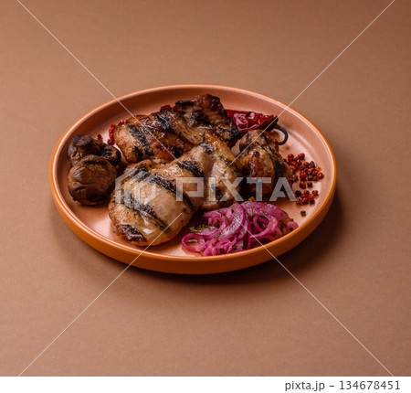 Chicken breast cooked on a grill or barbecue with sauce. Grilled chicken Chicken breast cooked on a grill or barbecue with sauce. Grilled chicken 134678451