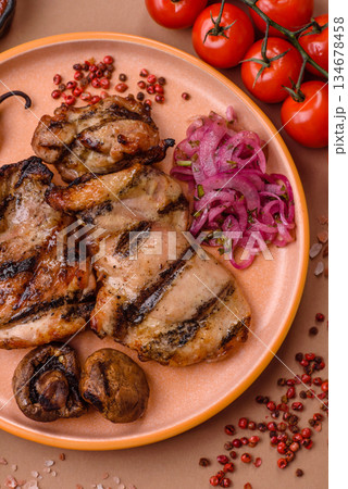 Chicken breast cooked on a grill or barbecue with sauce. Grilled chicken 134678458