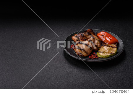 Chicken breast cooked on a grill or barbecue with sauce. Grilled chicken Chicken breast cooked on a grill or barbecue with sauce. Grilled chicken 134678464