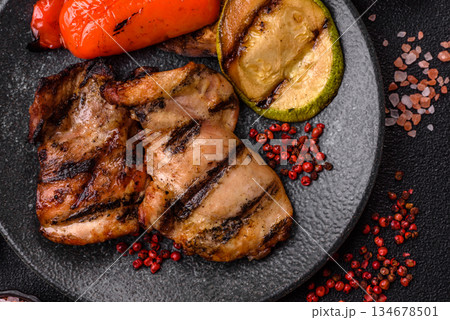 Chicken breast cooked on a grill or barbecue with sauce. Grilled chicken Chicken breast cooked on a grill or barbecue with sauce. Grilled chicken 134678501