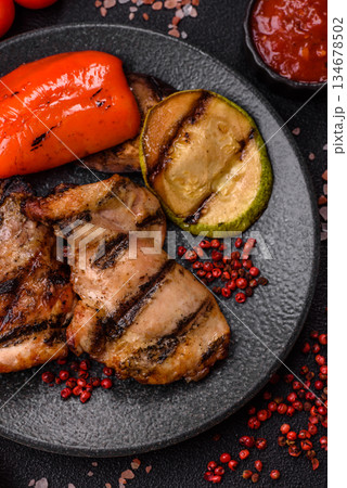 Chicken breast cooked on a grill or barbecue with sauce. Grilled chicken Chicken breast cooked on a grill or barbecue with sauce. Grilled chicken 134678502