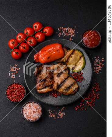 Chicken breast cooked on a grill or barbecue with sauce. Grilled chicken Chicken breast cooked on a grill or barbecue with sauce. Grilled chicken 134678506