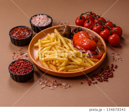 French fries cooked in oil, crispy golden chips, unhealthy food. French fries as a background French fries cooked in oil, crispy golden chips, unhealthy food. French fries as a background 134678541