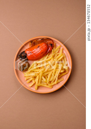 French fries cooked in oil, crispy golden chips, unhealthy food. French fries as a background French fries cooked in oil, crispy golden chips, unhealthy food. French fries as a background 134678552