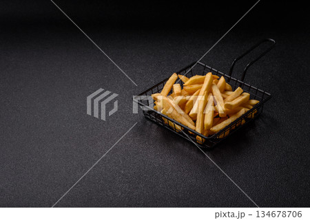 French fries are salty, crispy, and fried in oil, unhealthy takeaway food. French fries 134678706