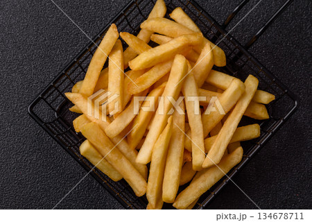French fries are salty, crispy, and fried in oil, unhealthy takeaway food. French fries French fries are salty, crispy, and fried in oil, unhealthy takeaway food. French fries 134678711