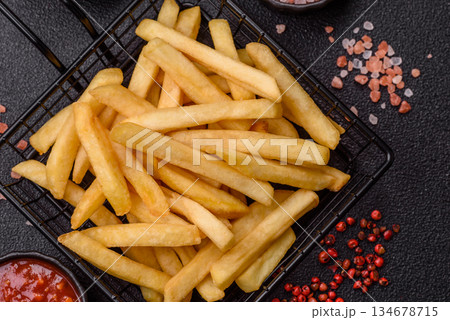 French fries are salty, crispy, and fried in oil, unhealthy takeaway food. French fries French fries are salty, crispy, and fried in oil, unhealthy takeaway food. French fries 134678715
