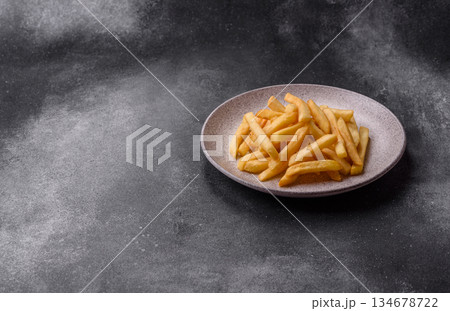 French fries are salty, crispy, and fried in oil, unhealthy takeaway food. French fries French fries are salty, crispy, and fried in oil, unhealthy takeaway food. French fries 134678722