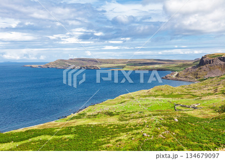Rugged coastline and blue sea on Isle of Skye Scotland 134679097