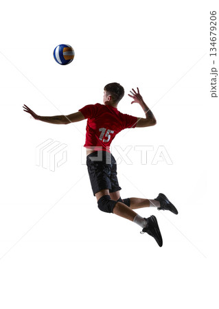 Volleyball player jumping and hitting ball isolated on white background. Volleyball player jumping and hitting ball isolated on white background. 134679206