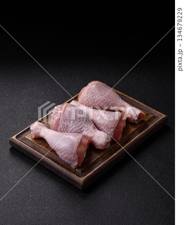 Raw chicken legs, poultry meat on the bone for barbecue. Chicken legs as a food background Raw chicken legs, poultry meat on the bone for barbecue. Chicken legs as a food background 134679229