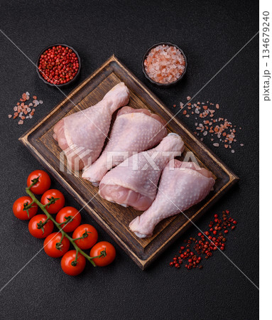 Raw chicken legs, poultry meat on the bone for barbecue. Chicken legs as a food background 134679240