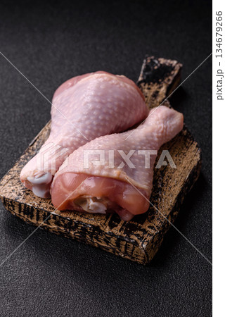 Raw chicken legs, poultry meat on the bone for barbecue. Chicken legs as a food background 134679266