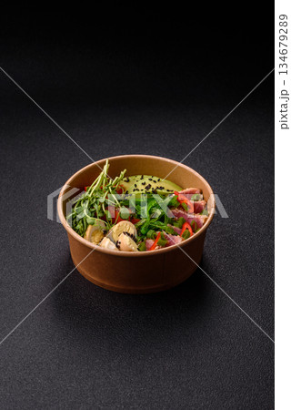 Seared tuna tataki in a bowl with sesame seeds, rice, and vegetables. Tuna tataki 134679289