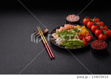 A prawn or shrimp bowl with rice, tomatoes, sauce, and vegetables, Asian food. Prawn or shrimp 134679414