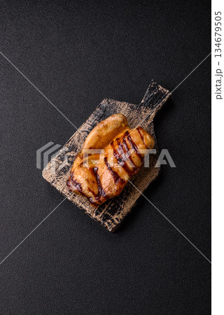 Grilled boneless chicken legs baked on the barbecue for lunch. Grilled chicken as a background Grilled boneless chicken legs baked on the barbecue for lunch. Grilled chicken as a background 134679505