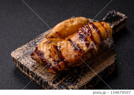 Grilled boneless chicken legs baked on the barbecue for lunch. Grilled chicken as a background Grilled boneless chicken legs baked on the barbecue for lunch. Grilled chicken as a background 134679507